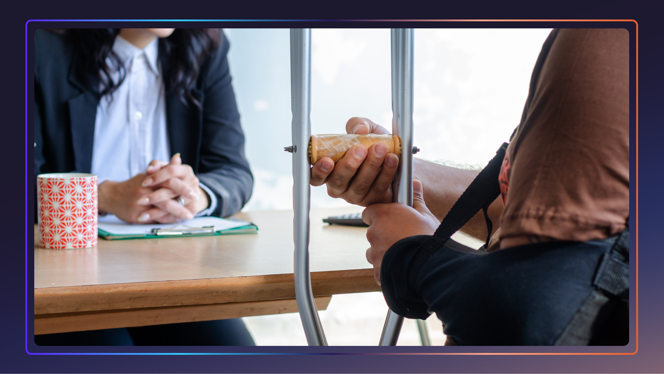 Person with an arm in a sling, holding a crutch, and meeting with a personal injury lawyer at a desk.