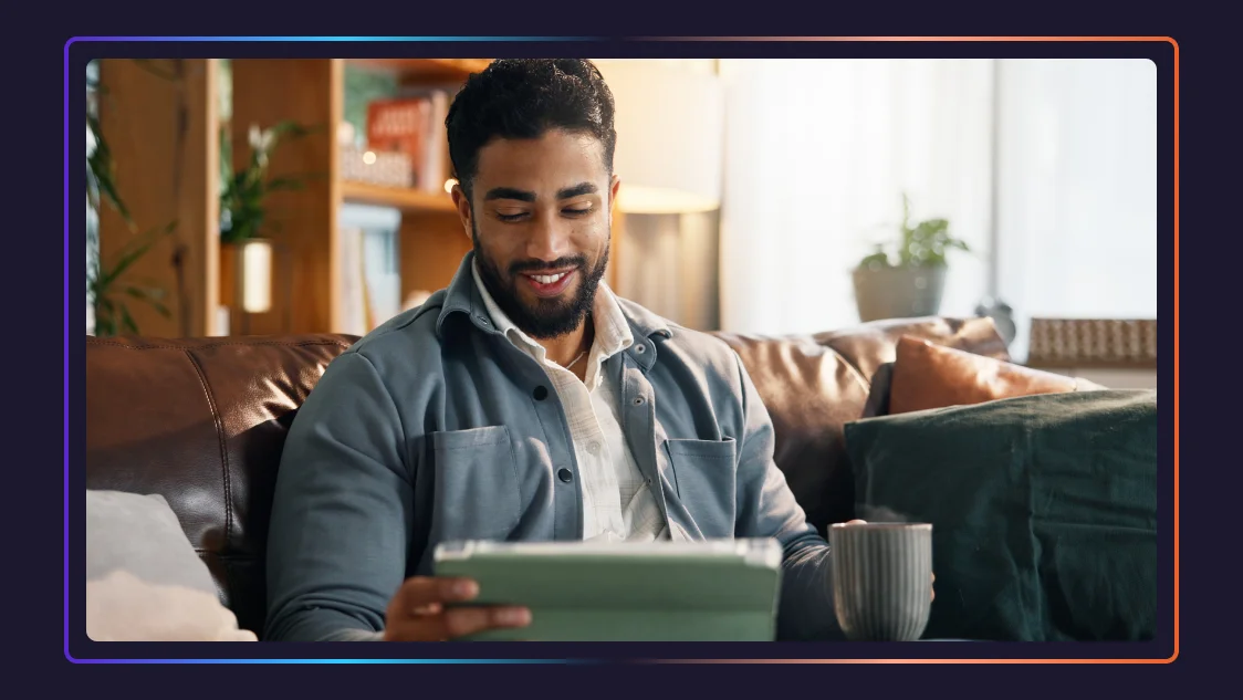 A man holding a cup of coffee uses AI services on his tablet