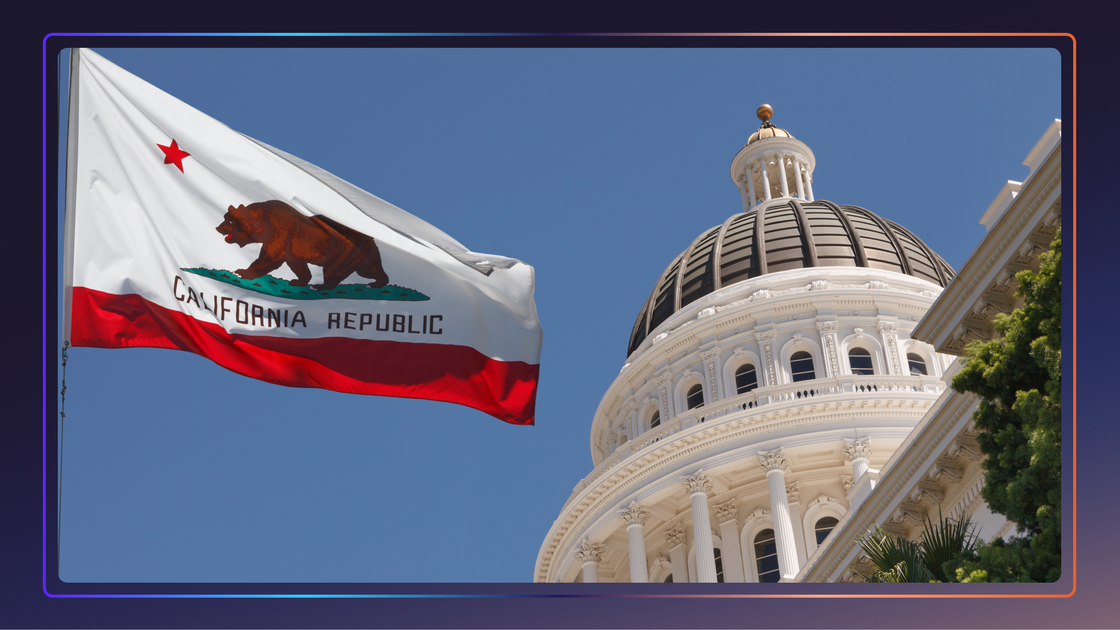 The California state flag flies in front of the state capitol building and a clear blue sky.