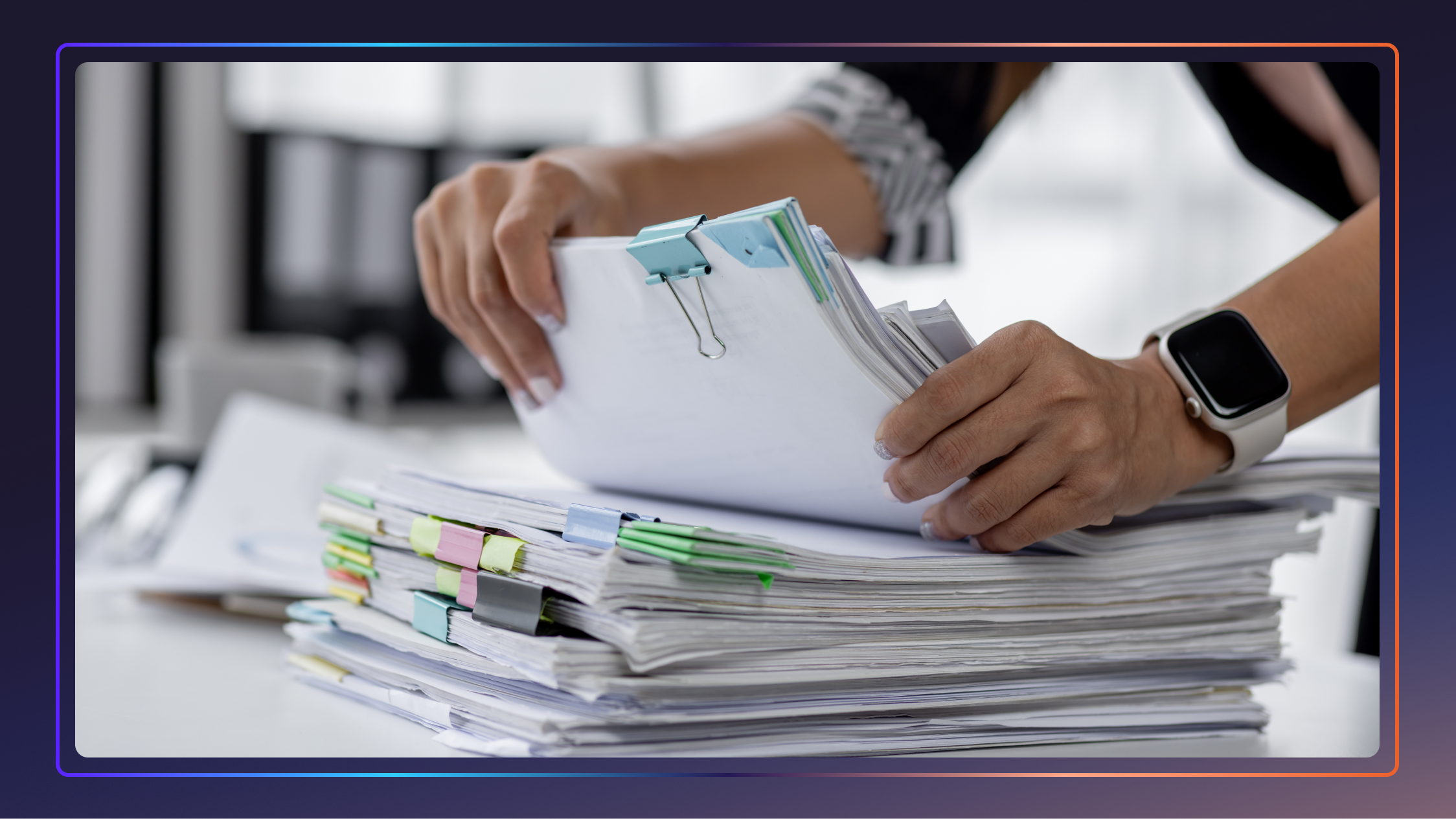 Close-up of a woman’s hands as she shuffles through a large stack of bound papers.
