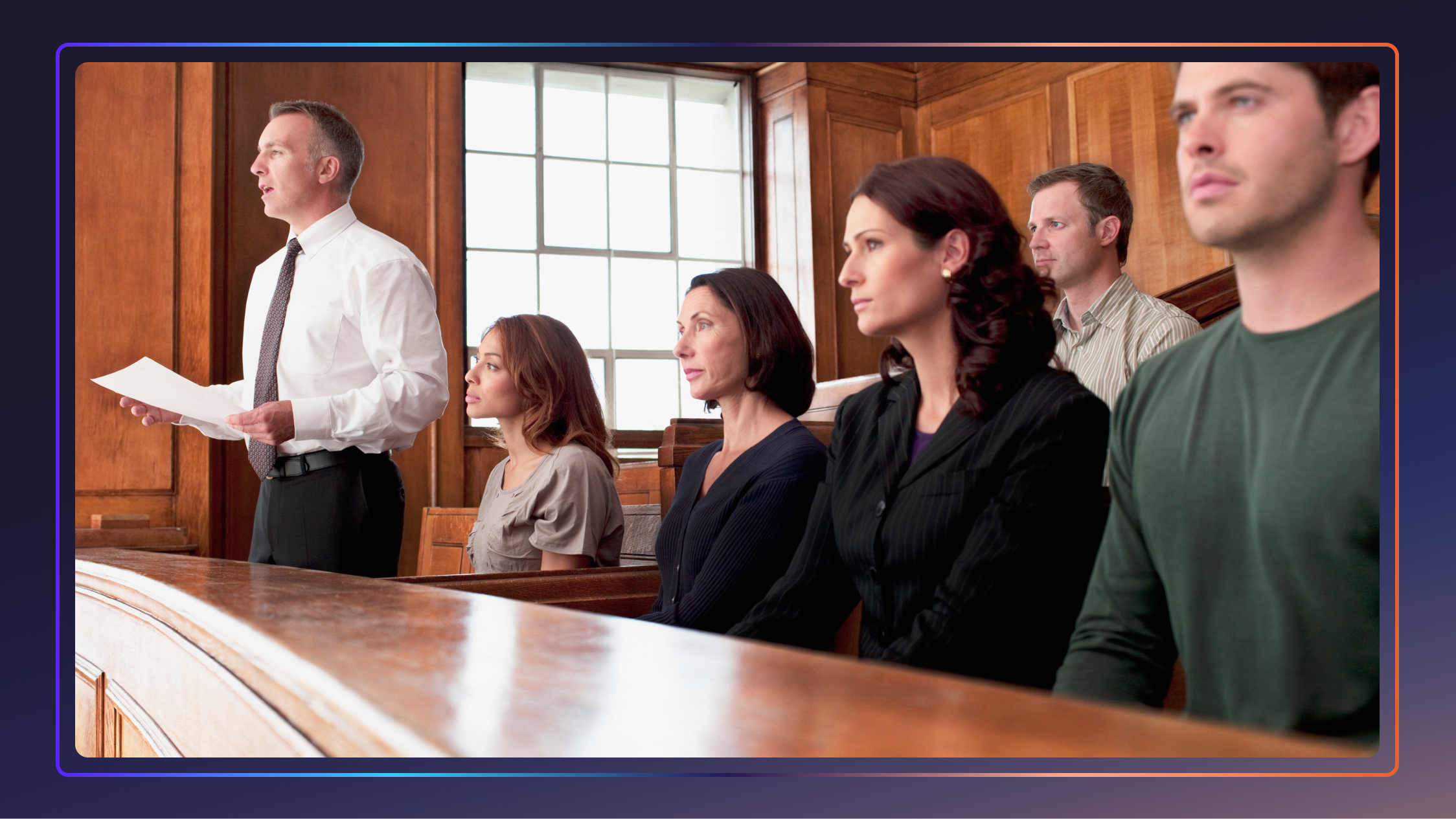 A jury sits in the jury box in a courtroom, and the foreman stands and speaks while holding a piece of paper.