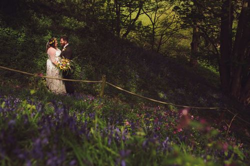 Married couple at Fordhall Farm amongst bluebells