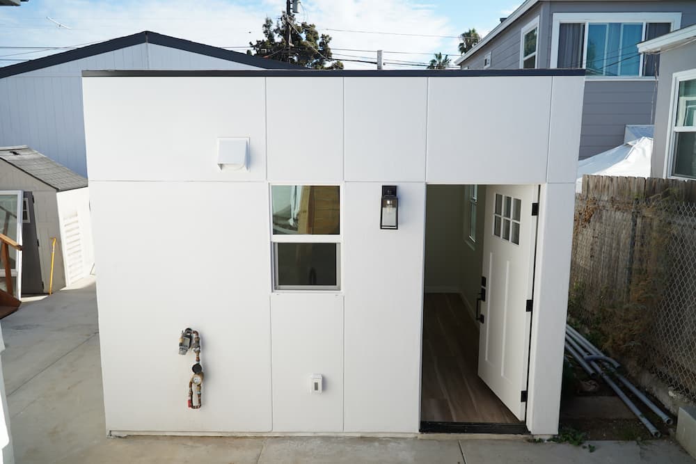 240 sqft garage conversion studio ADU with 1 bath, kitchen, and in-unit laundry by ADU Geeks.