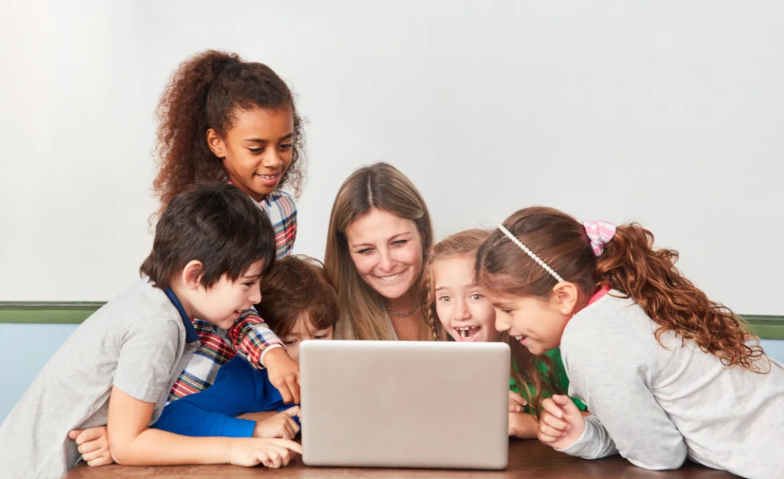 kids with a parent looking at a computer