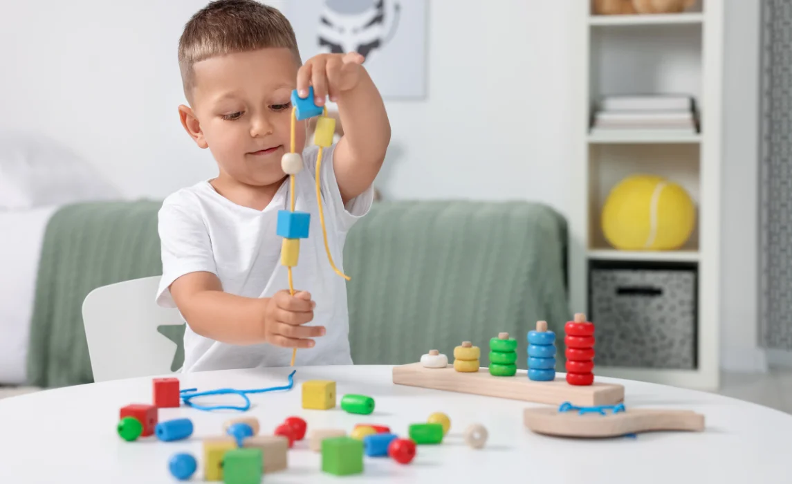kid playing with blocks and rope