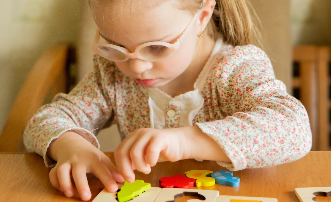 kid playing puzzle on table