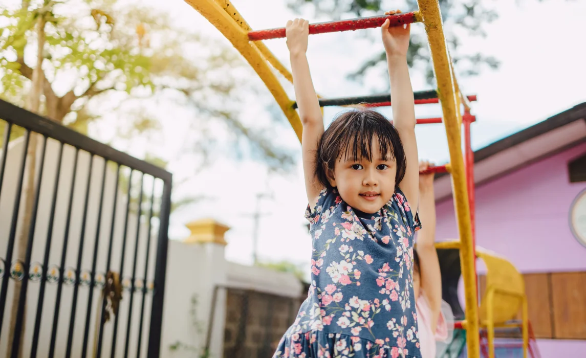 kid hanging on the playground