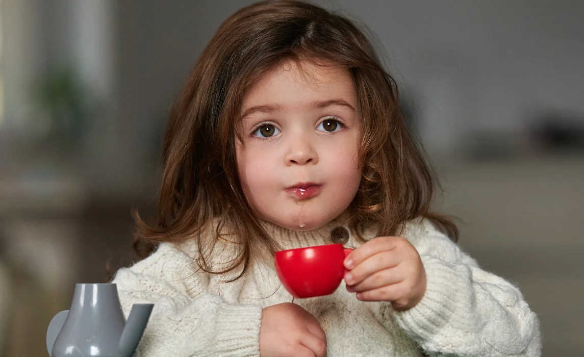kid holding a tea cup