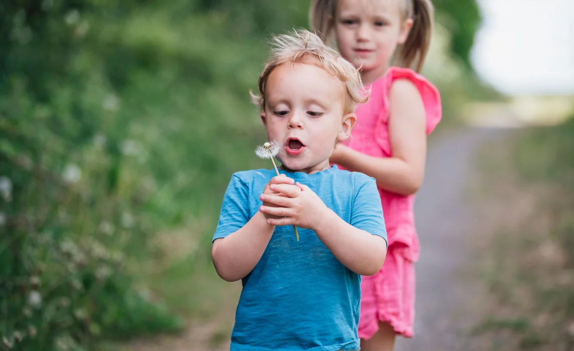 kid blowing the flower