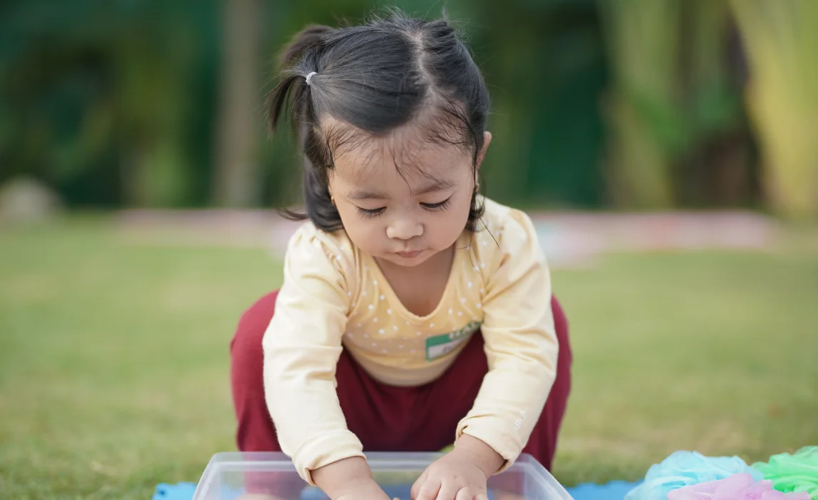 kid playing with sand