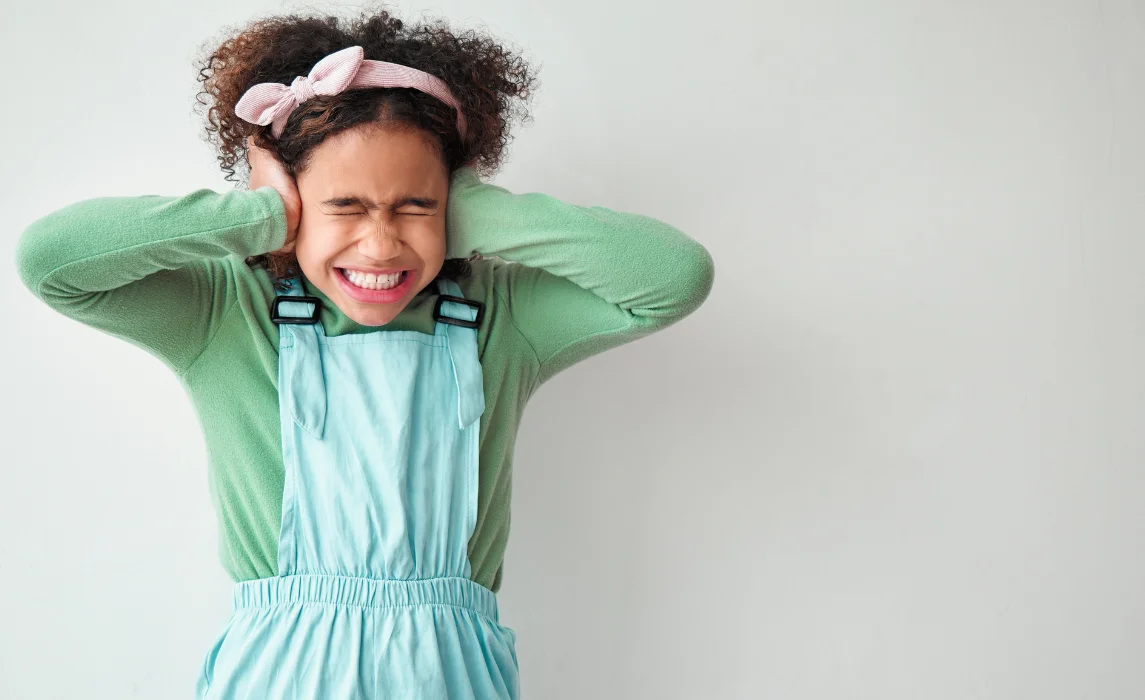 kid overwhelmed with noises in white background