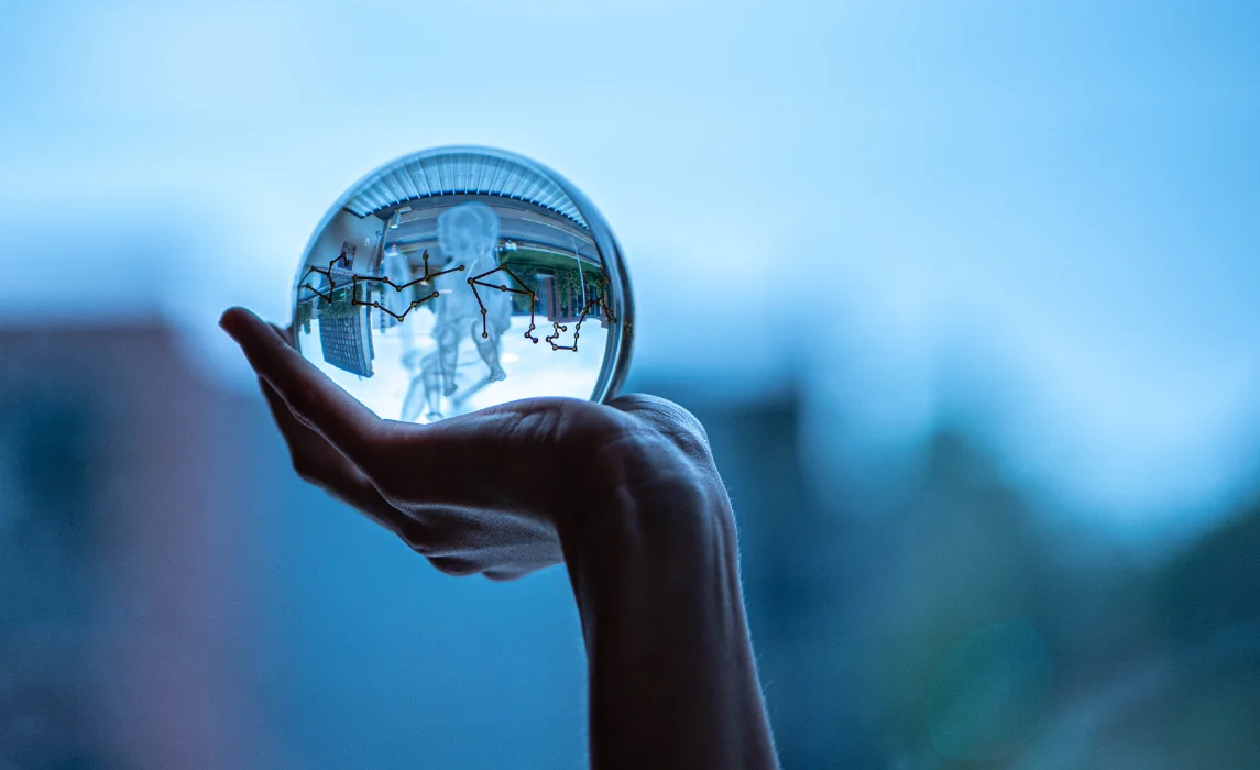 hand holding a silver ball