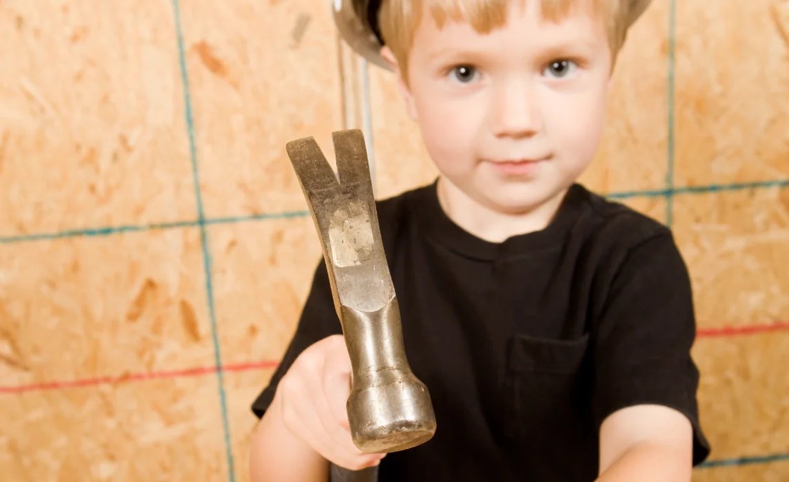 kid holding a hammer