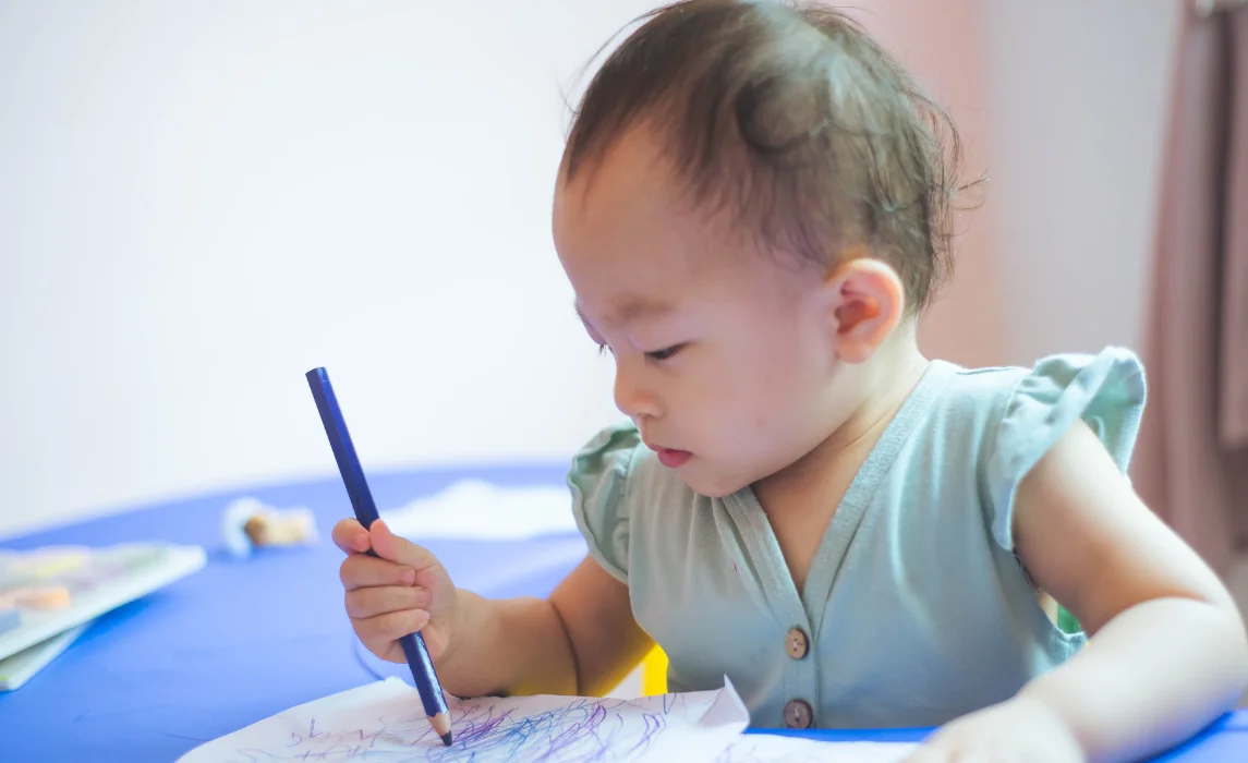 baby writing using a pencil