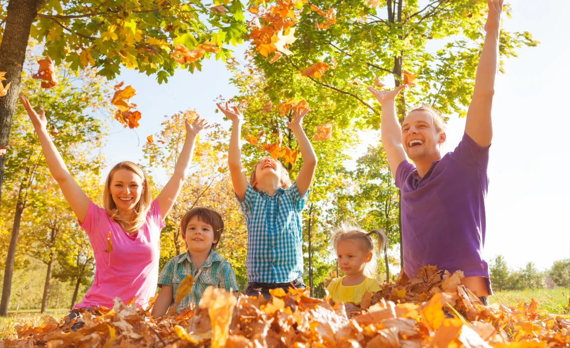 family playing with leaves