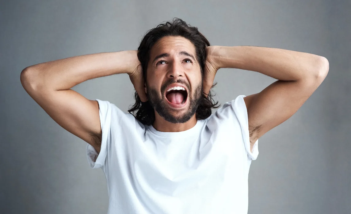 man covering his ears