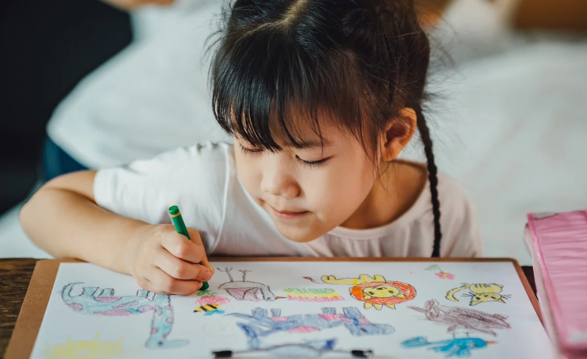 kid coloring in her bedroom