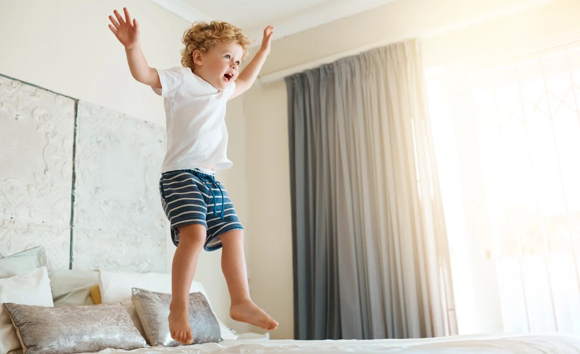 kid jumping on the bed