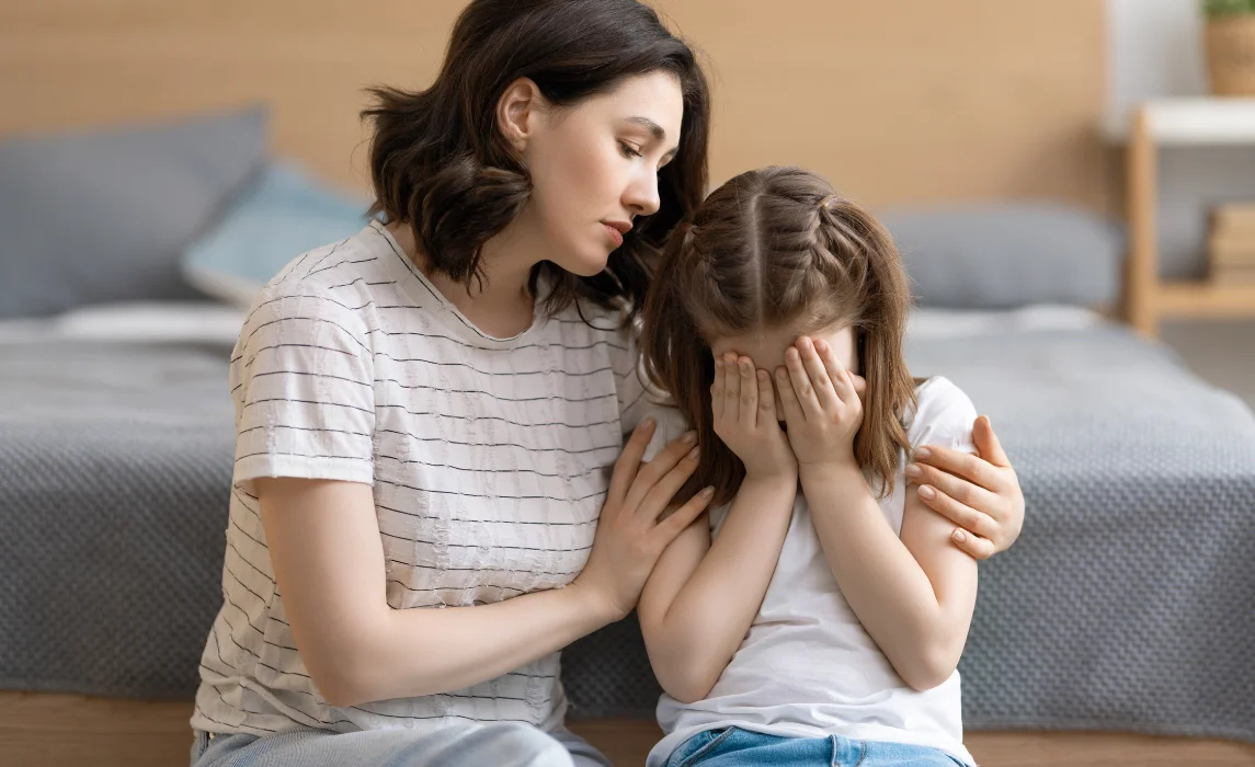 kid crying with her mom