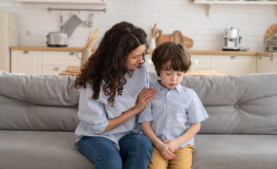 kid comforting her son
