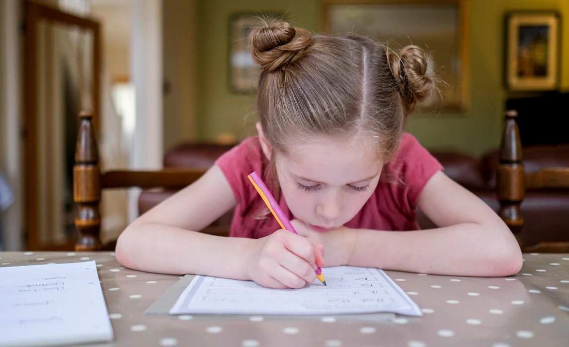 kid writing on the table