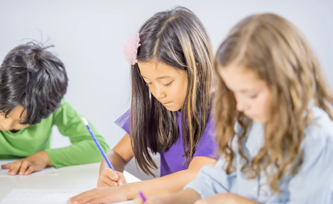 elementary students writing in the school