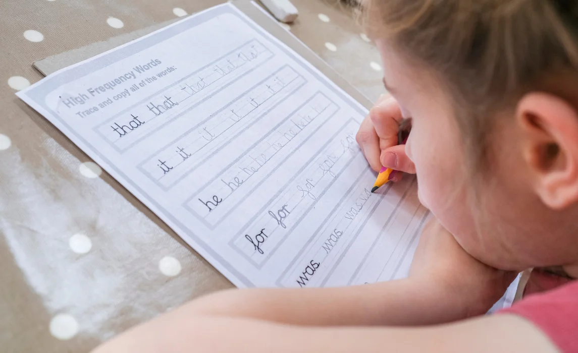 kid writing with his pencil