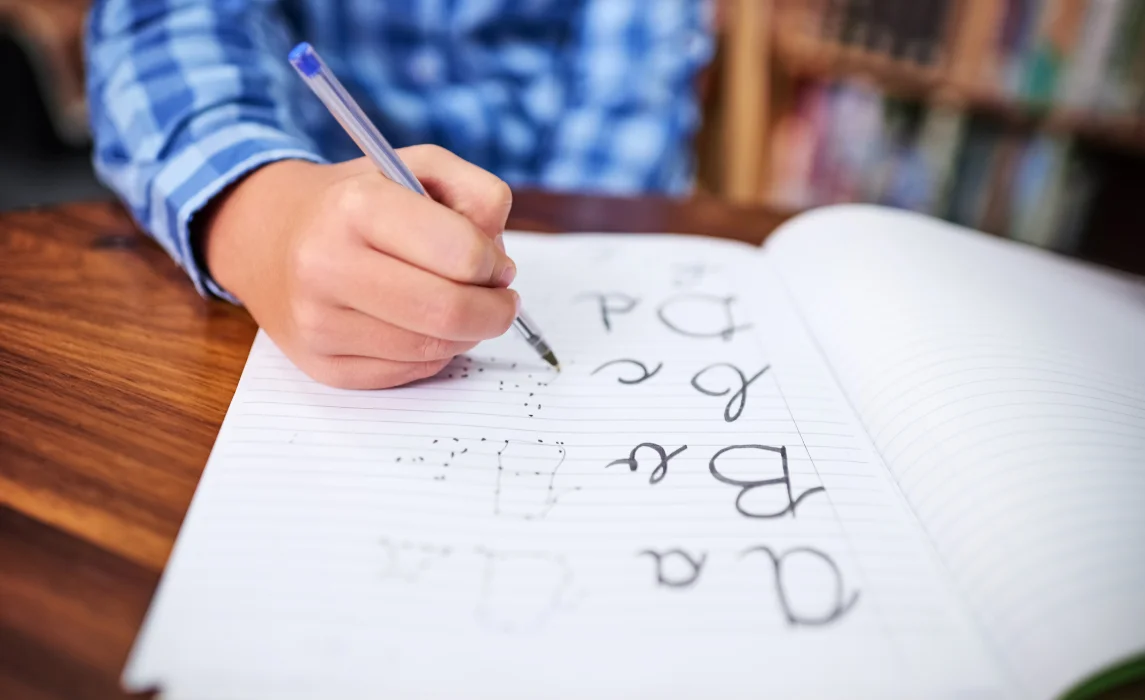kid writing using a ballpen