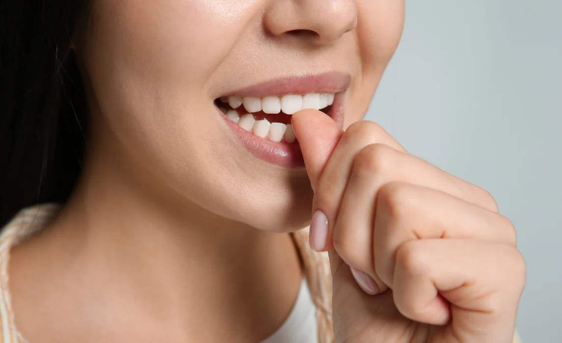 girl biting her nails