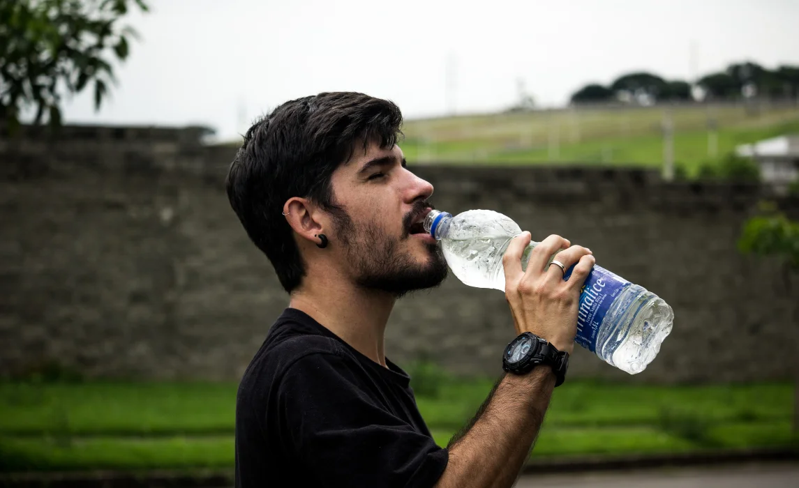 guy drinking water from the bottle