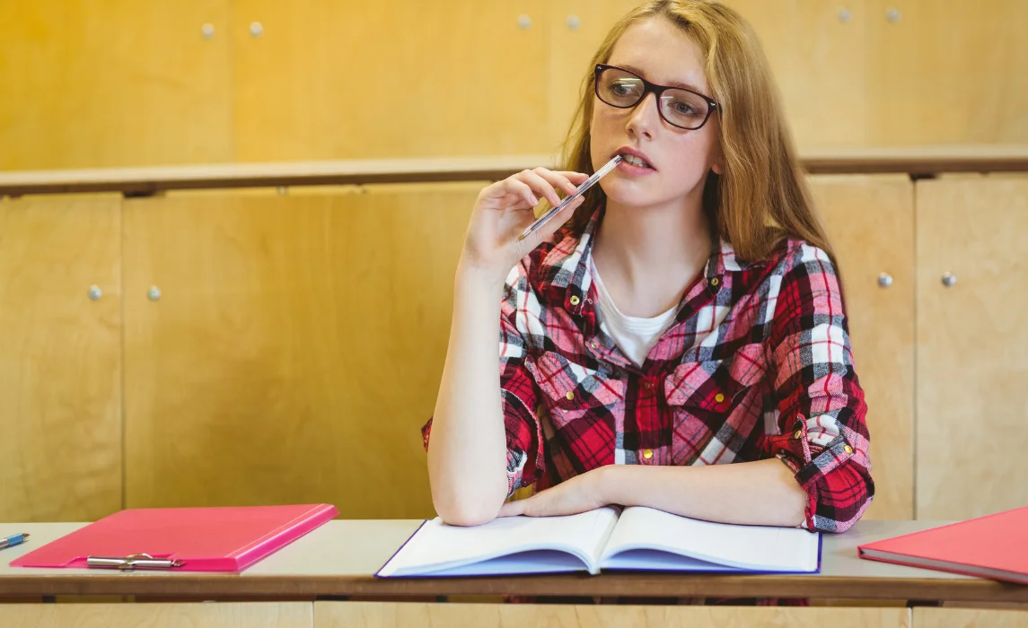 girl chewing her ballpen