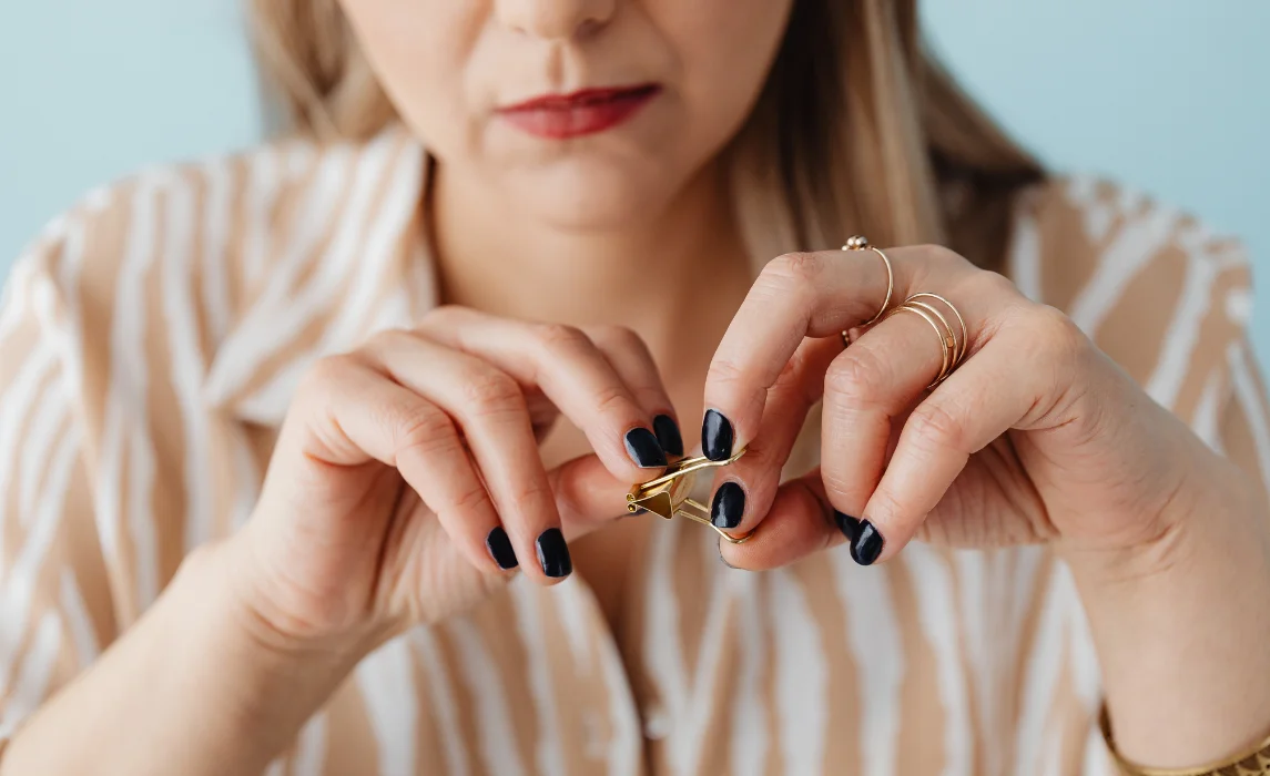 girl playing with golden clip