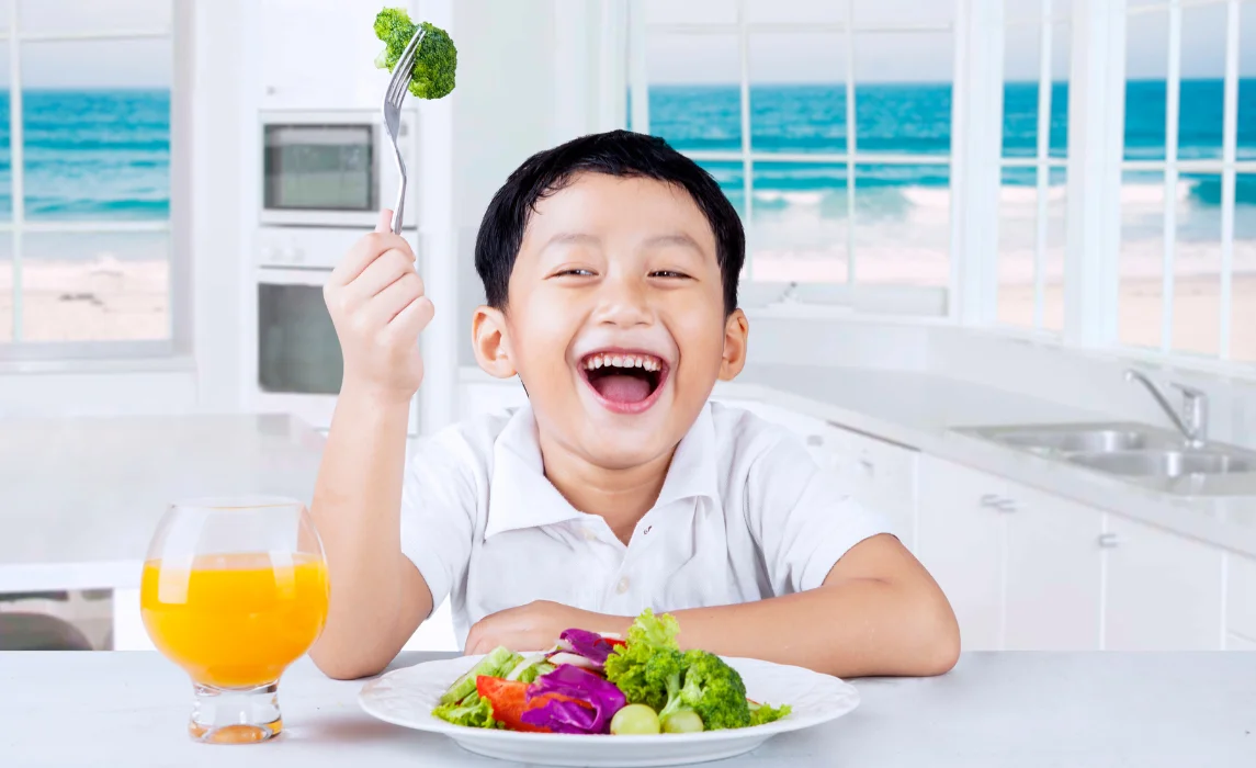 kid eating vegetable in plate