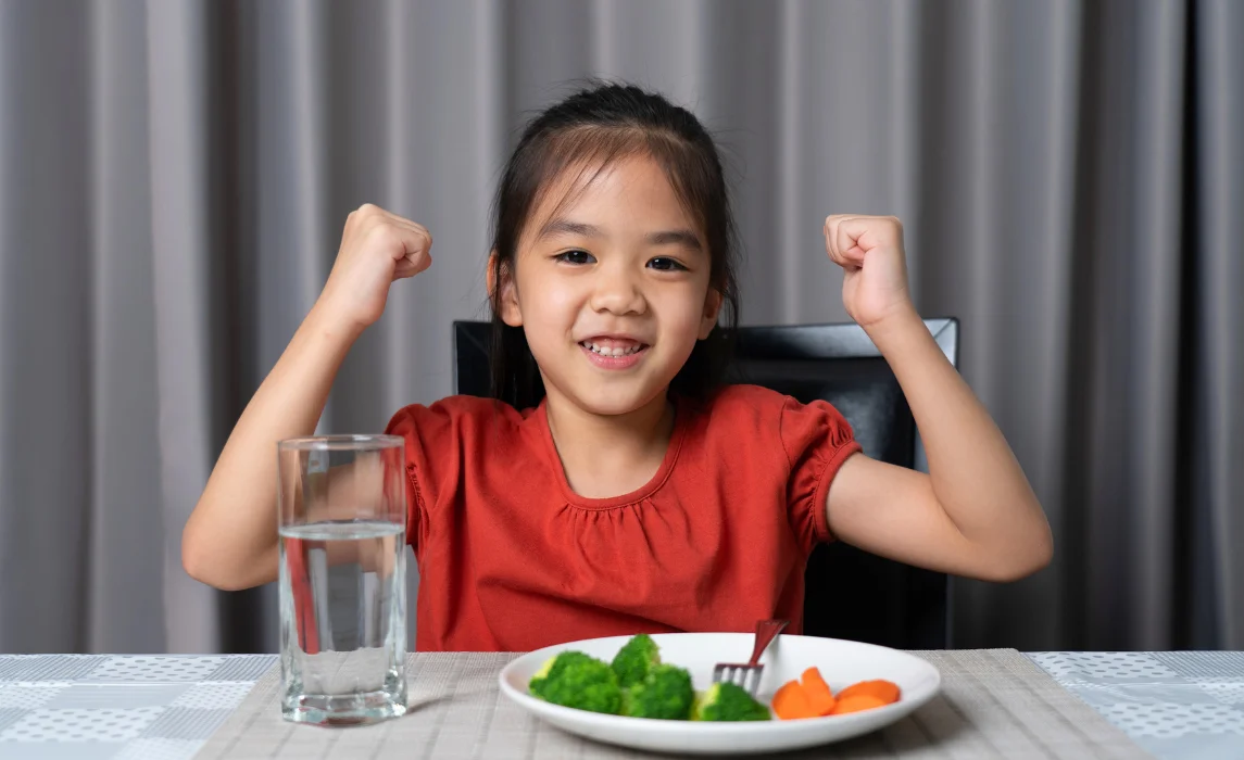 kid happily eating vegetable