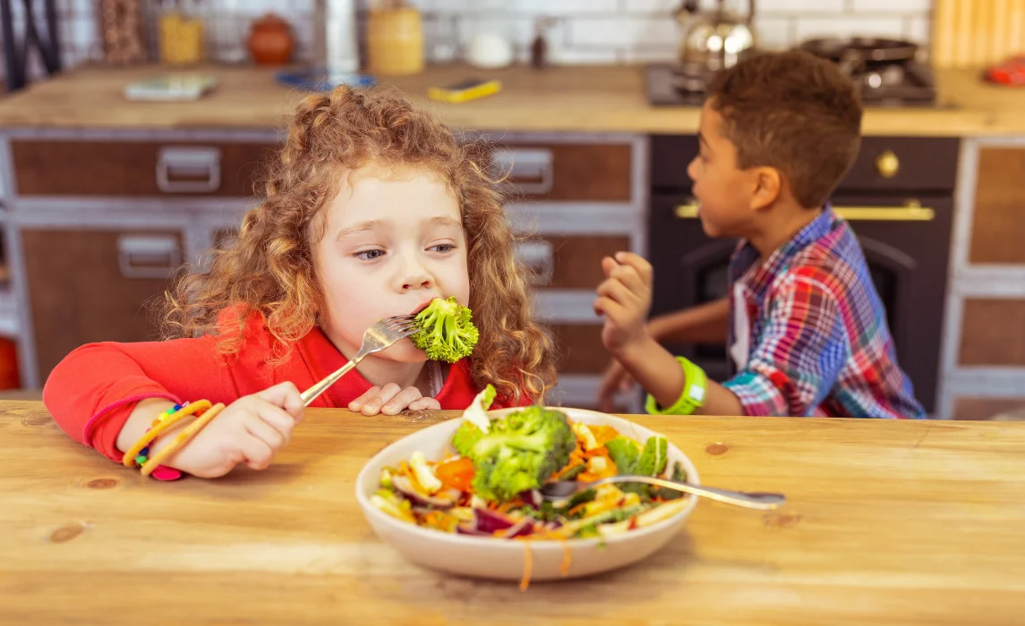 kid eating broccoli