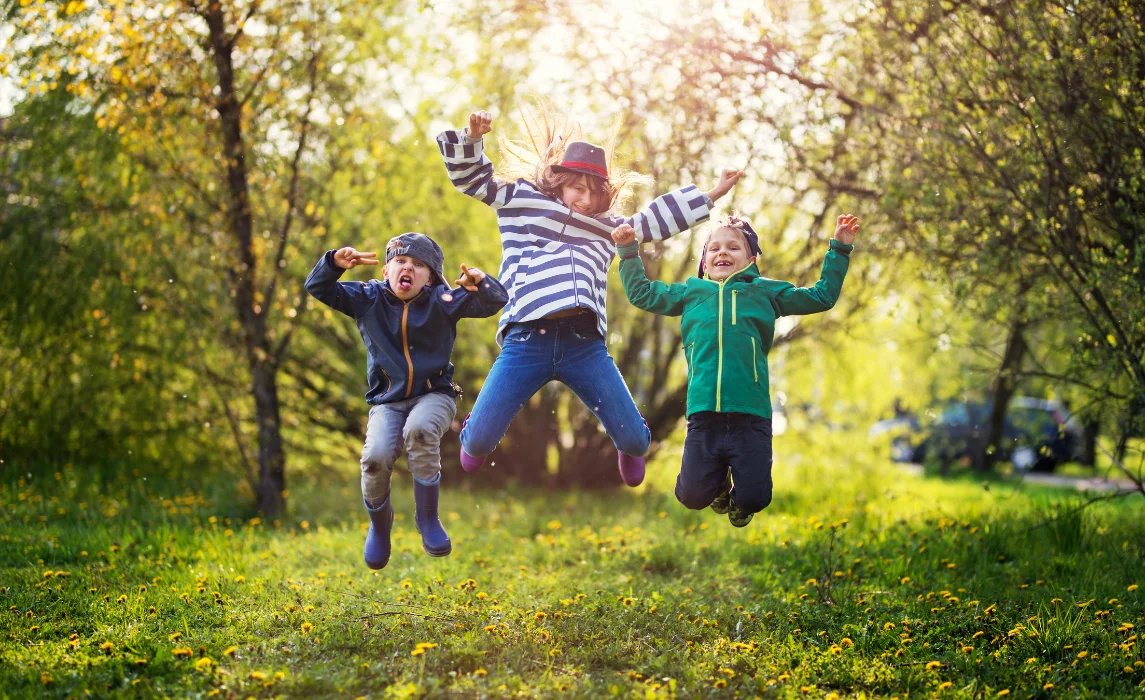 kids jumping inside the forest