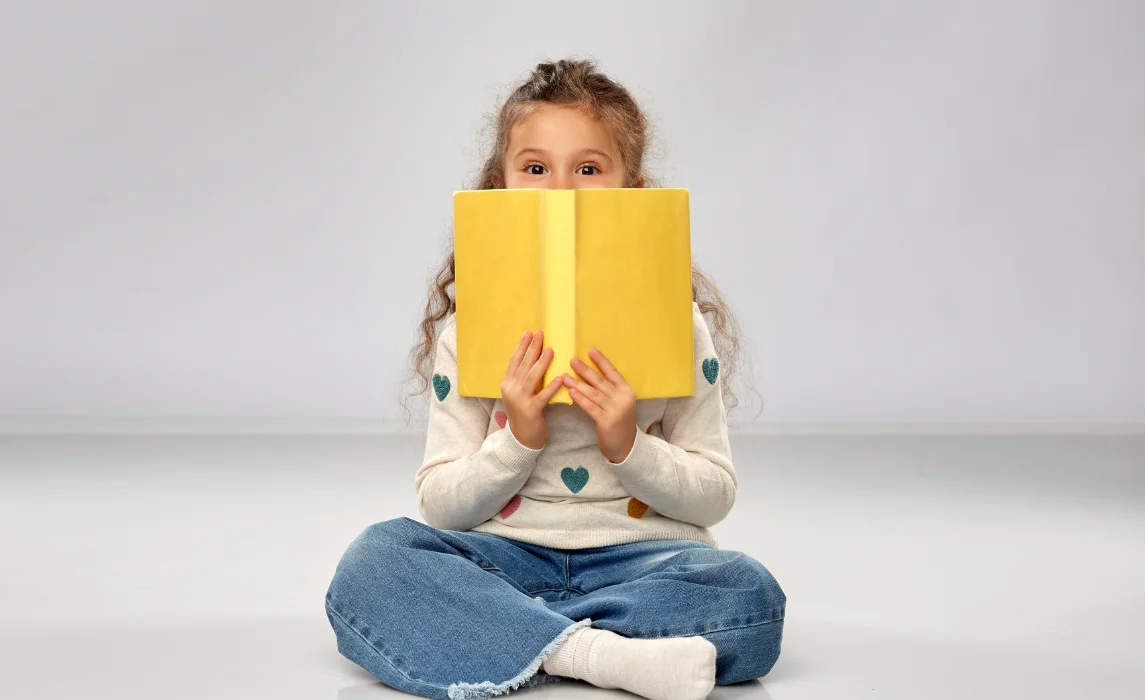 girl reading yellow book