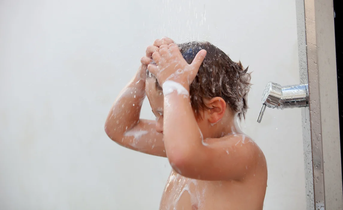 kid showering in their home