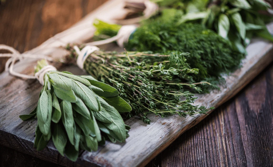 closeup of garden herbs on a wooden tray