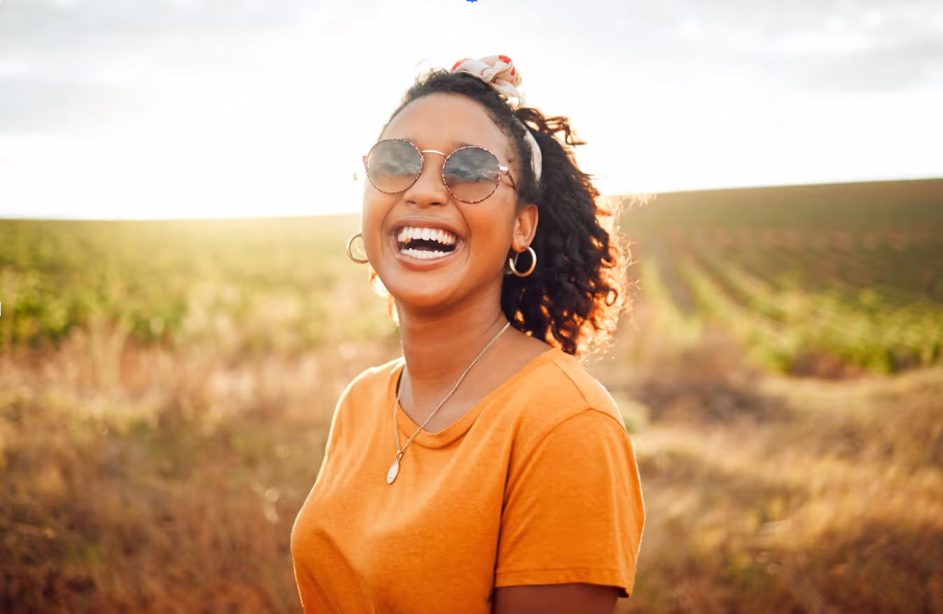 Woman laughing outdoors after successful allergy treatment