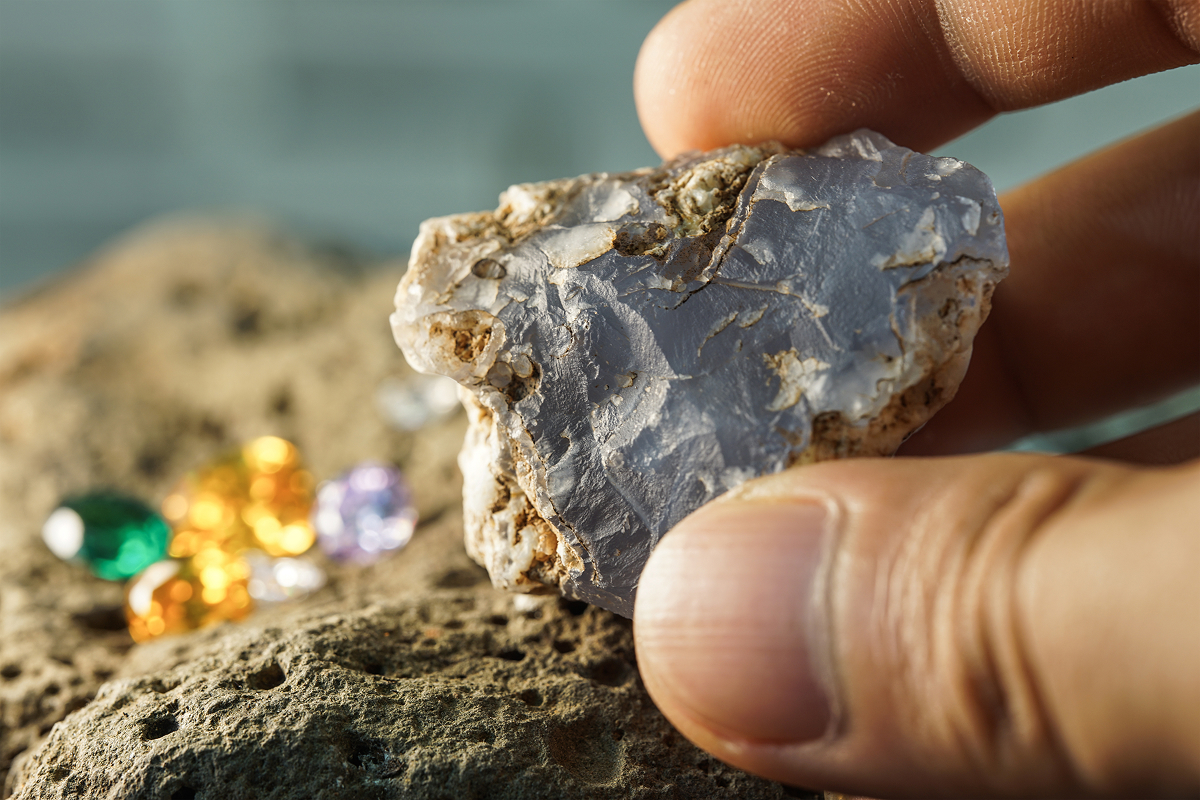 Someone holding a natural gemstone