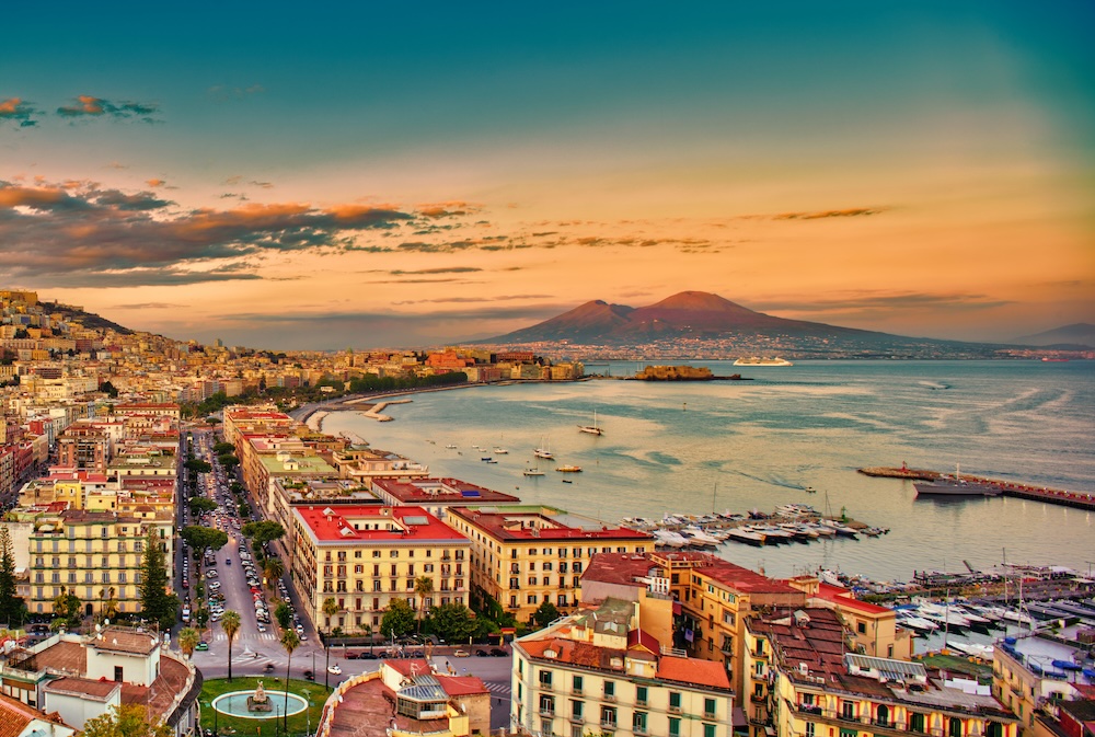 Sail out of the Bay of Naples at sunset, with Mt Vesuvius in the background