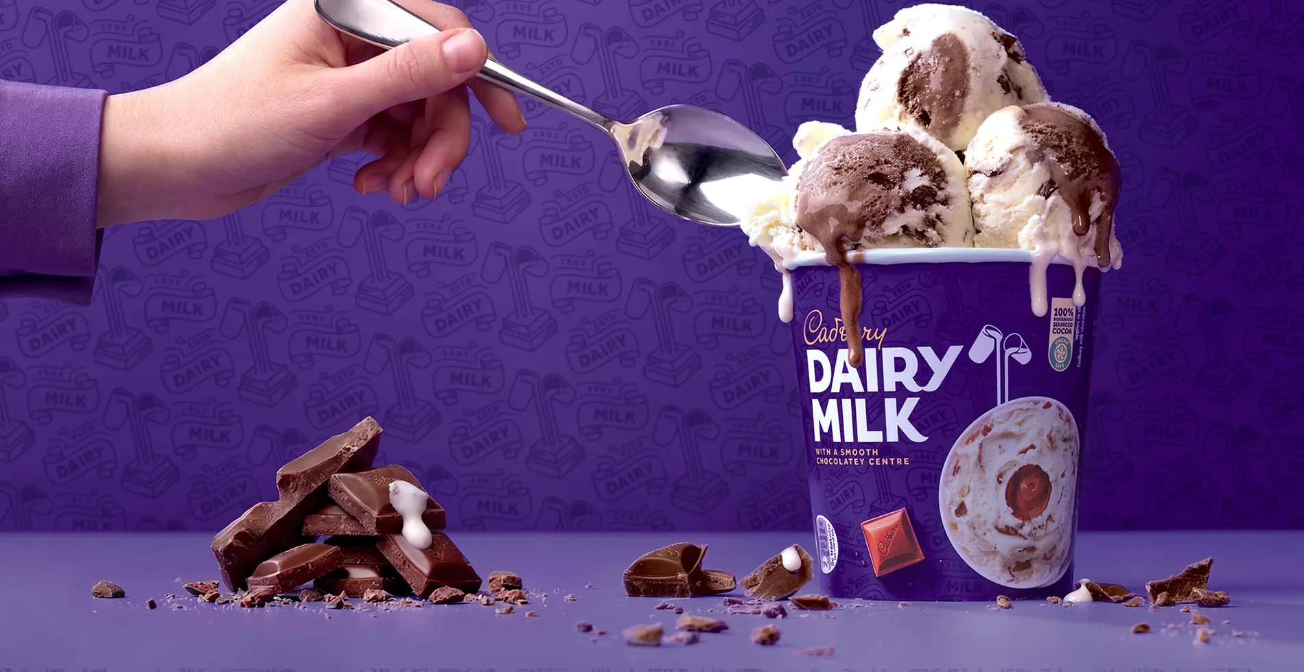 Dynamic redesign for Cadbury Dairy Milk ice cream tubs (produced by Froneri), using high-energy product photography of a scoop and chocolate shards against the iconic Cadbury purple.