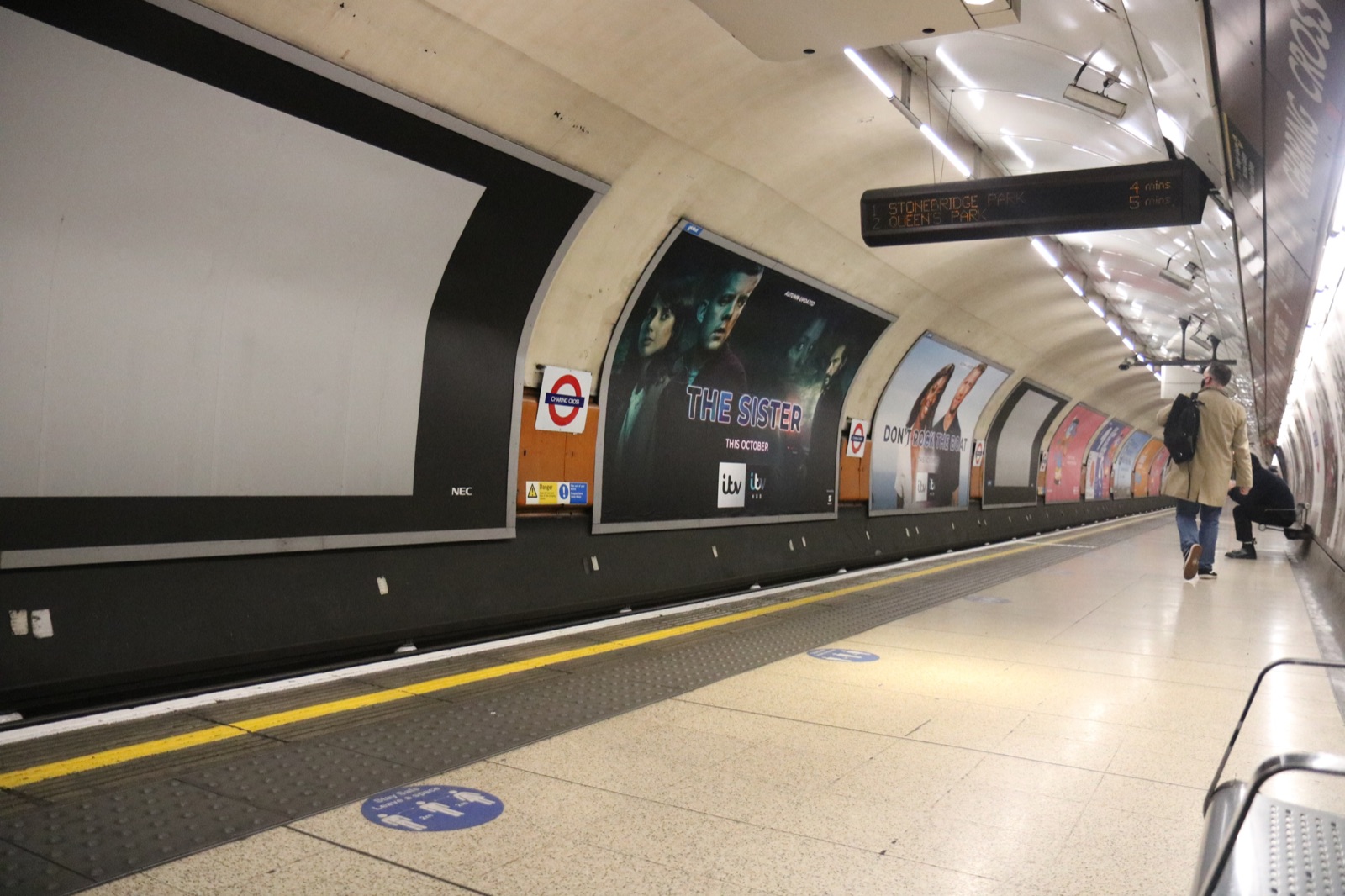 Advertising posters lining a London Underground platform at Charing Cross