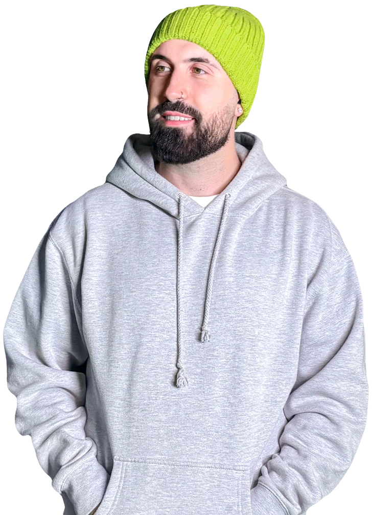 Rowen wearing a light gray hoodie and a bright green knit beanie, smiling and looking to the side against a plain background.