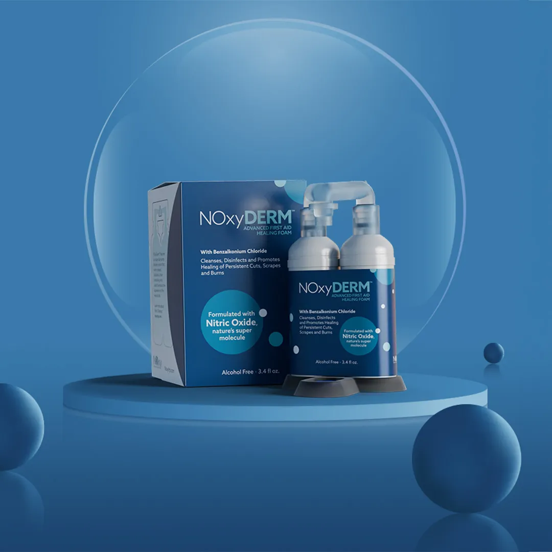 NOxyDERM first aid healing foam product with packaging and bottles displayed on a blue background.