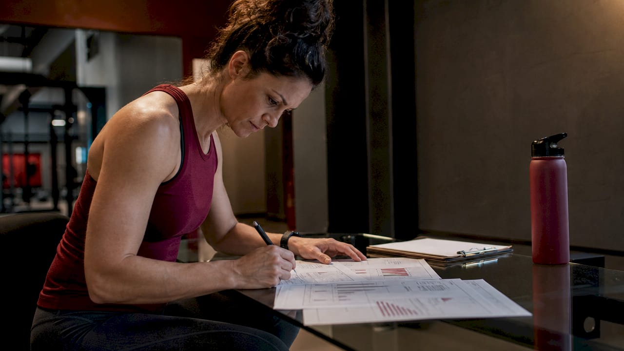 Female coach analyzing jump training graphs