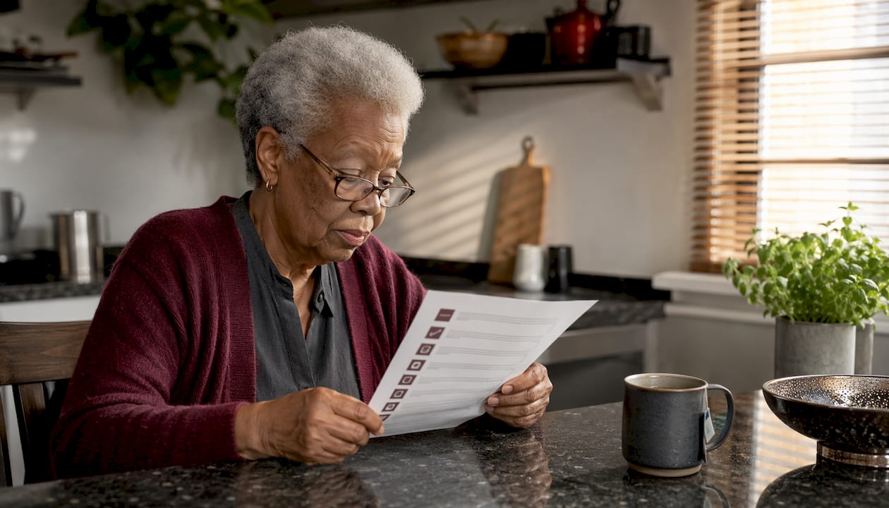 Senior woman reviewing fitness checklist at home