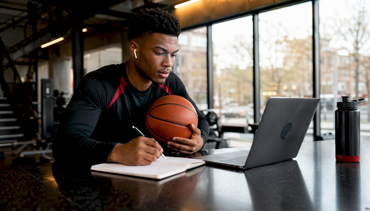 Athlete taking notes during remote coach marketplace session