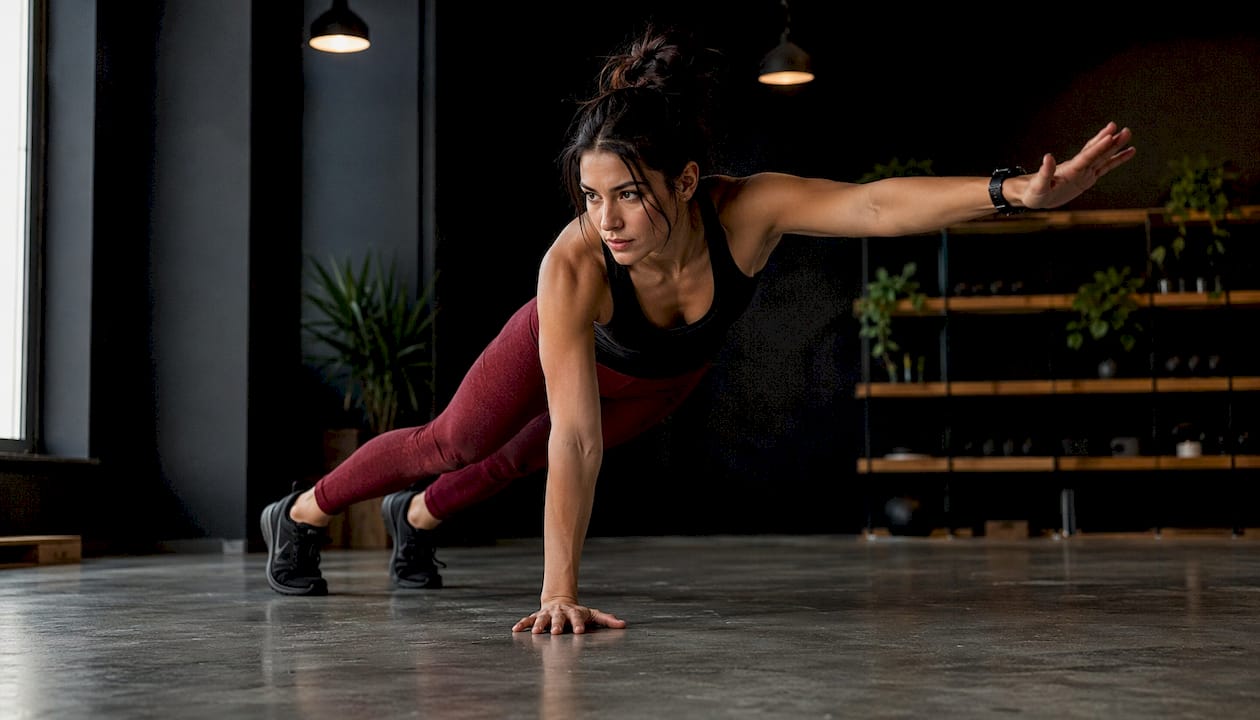 Woman performing plank in home gym